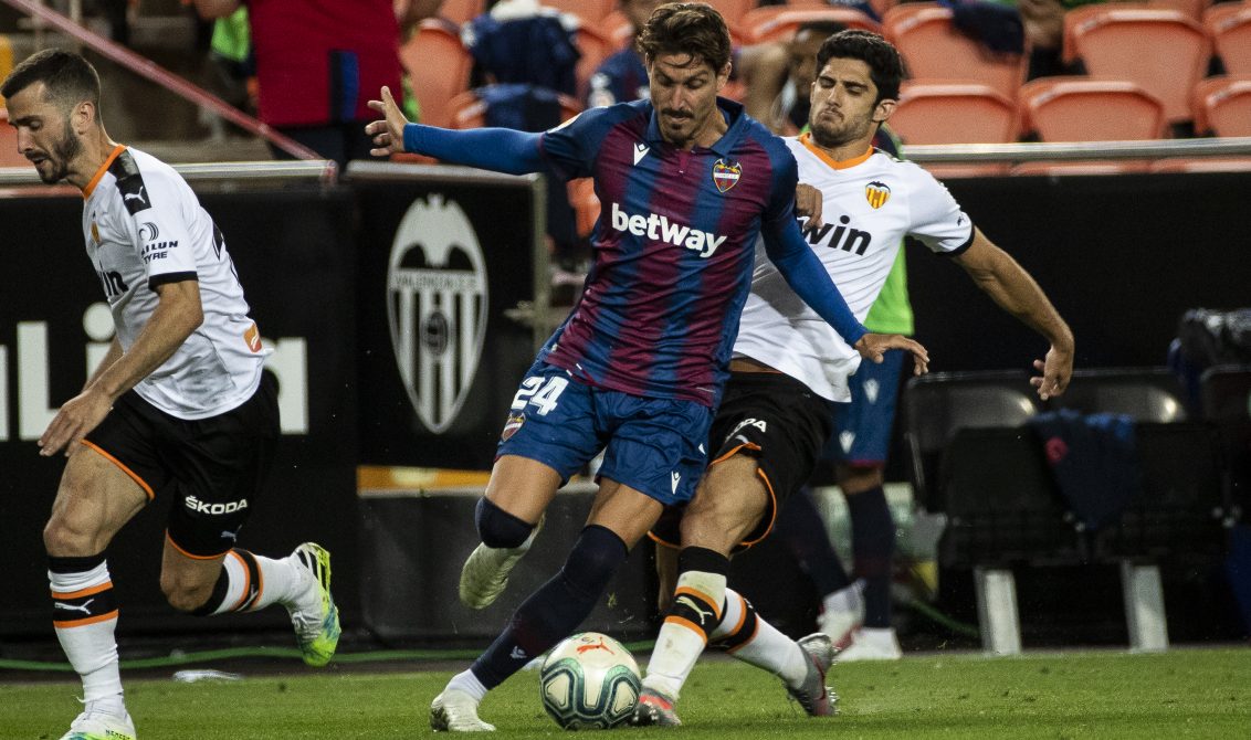 12 June 2020, Spain, Valencia: Levante's Jose Campana (C) and Valencia's Gonzalo Guedes (R) battle for the ball during the Spanish LaLiga soccer match between Valencia CF and Levante UD at Mestalla Stadium. Photo: J.M. FERNANDEZ/gtres/dpa