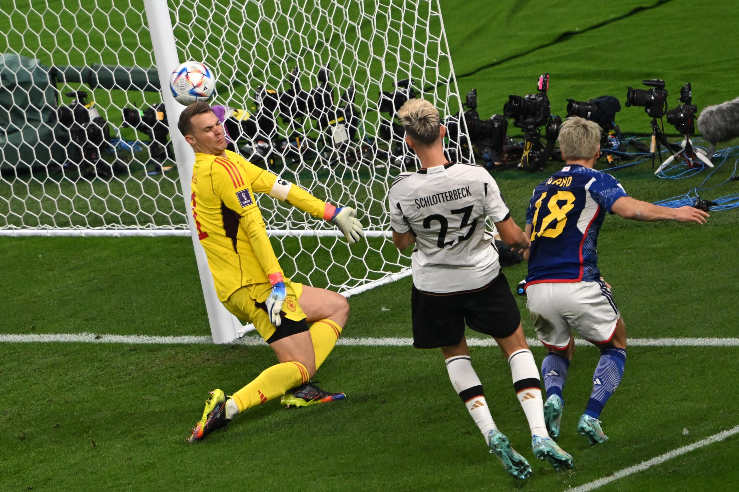 23 November 2022, Qatar, Al Rayyan: Japan's Takuma Asano scores his side's second goal past Germany's goalkeeper Manuel Neuer and Nico Schlotterbecr, during the FIFA World Cup Qatar 2022 Group E soccer match between Germany and Japan at Khalifa Internation al Stadium. Photo: Robert Michael/dpa