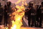 08 December 2022, Peru, Lima: Police officers stand behind burning barricades ignited by supporters of Peru's ousted President Castillo during a demonstration following Peru's Congress vote on Wednesday to remove Castillo from office and replace him with the vice president, shortly after Castillo tried to dissolve the legislature ahead of a planned vote on his ouster. Photo: Lucas Aguayo Araos/dpa